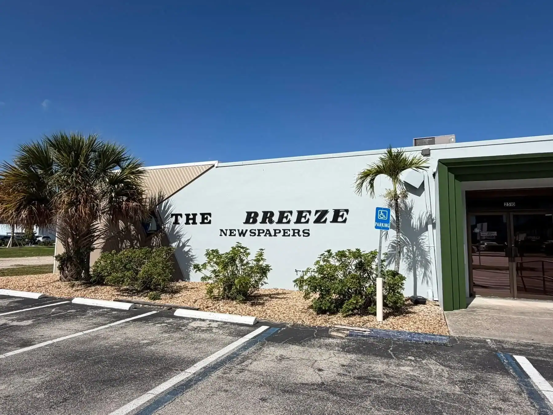 Office Building Exterior Painting Services in Southwest Florida Close up of 'THE BREEZE NEWSPAPERS' office building exterior, showcasing commercial painting in Southwest Florida.
