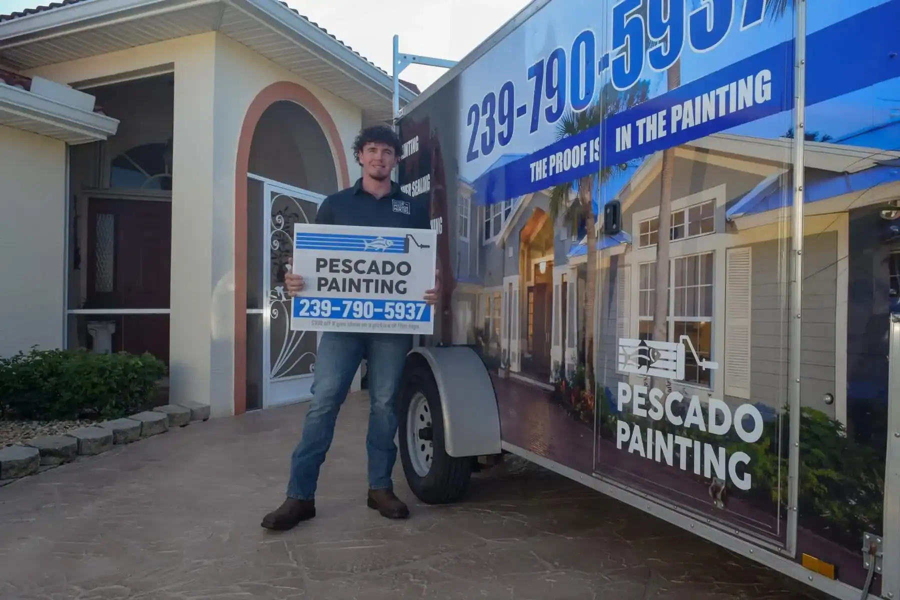 Pescado Painting Offering Residential Services in Southwest Florida Pescado Painting professional holding a sign in front of a branded trailer and house in Southwest Florida.